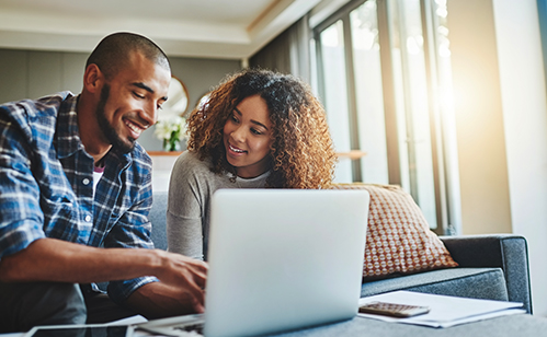 Couple in front of computer smiling