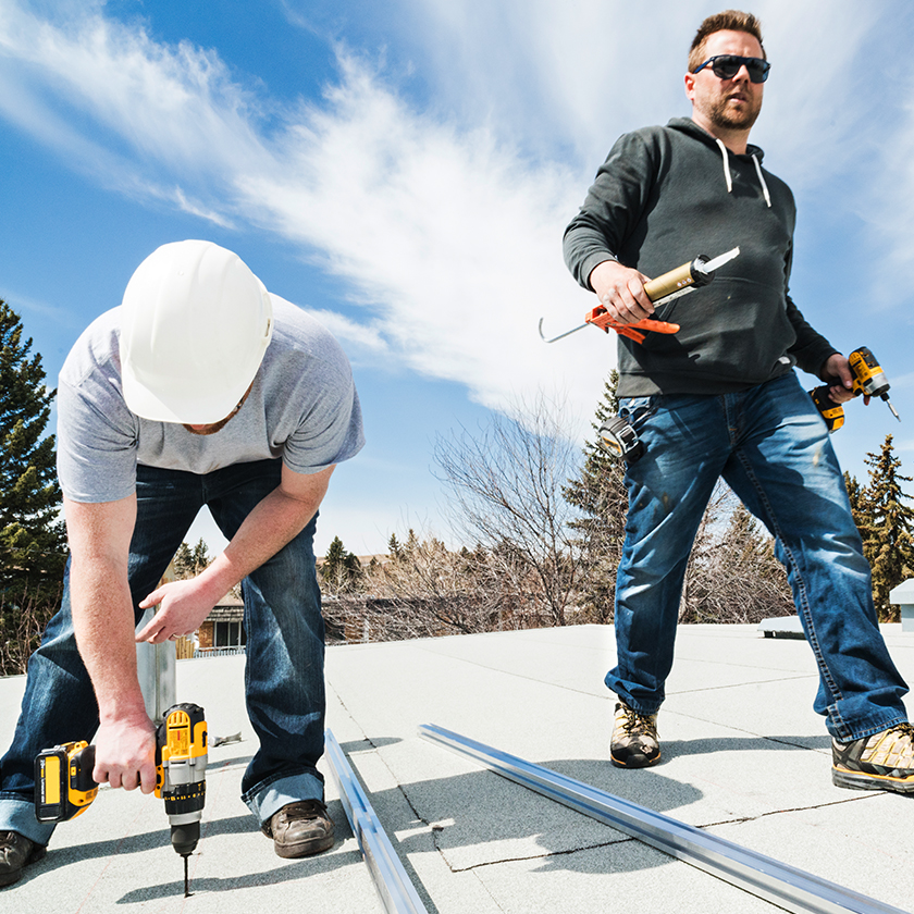 Two installers on a roof