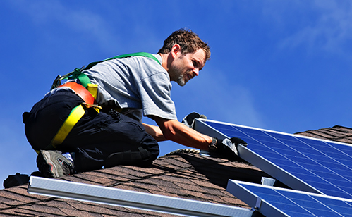 Installer placing a solar panel